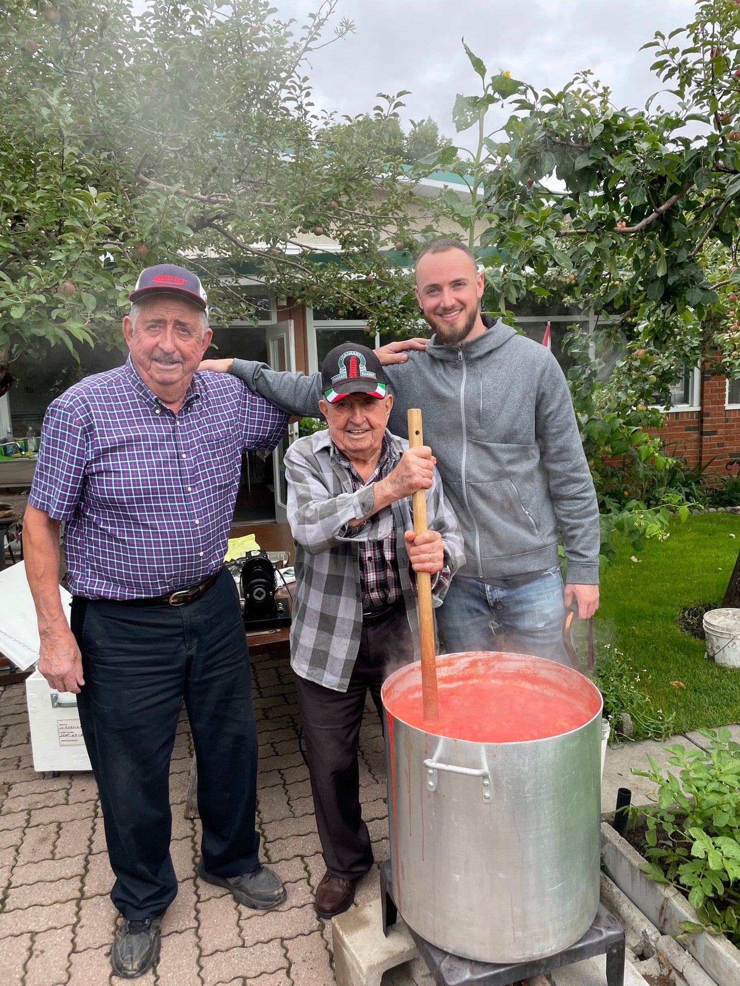 Matt Cusano Ciao Chili founder pictured with grandpa and uncle making a large batch of Italian sauce 